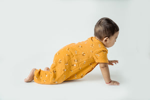 Toddler in golden lily grow suit