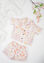 Organic cotton co-ord set with boteh print in earthy red, orange and yellow tones, collared shirt and matching shorts.