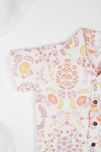 Organic cotton co-ord set with boteh print in earthy red, orange and yellow tones, collared shirt and matching shorts.