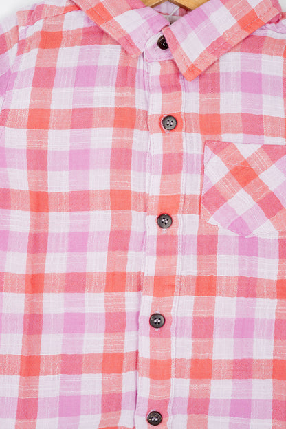 Boy's button-down double muslin organic cotton shirt, featuring deep red and purple checks and a classic collar.
