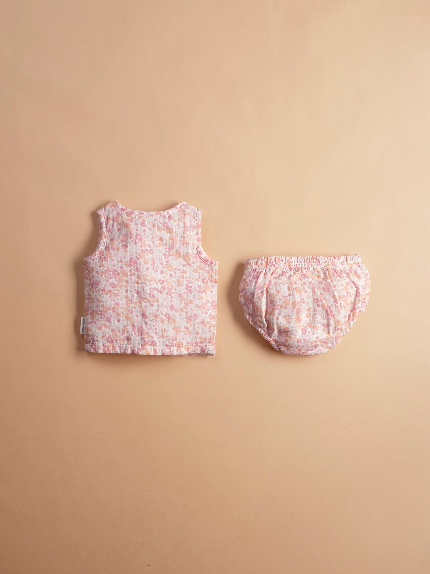 Soft muslin infant jhabla sei in cherry blossom print with matching bloomers-breathable and gentle for newborn skin.