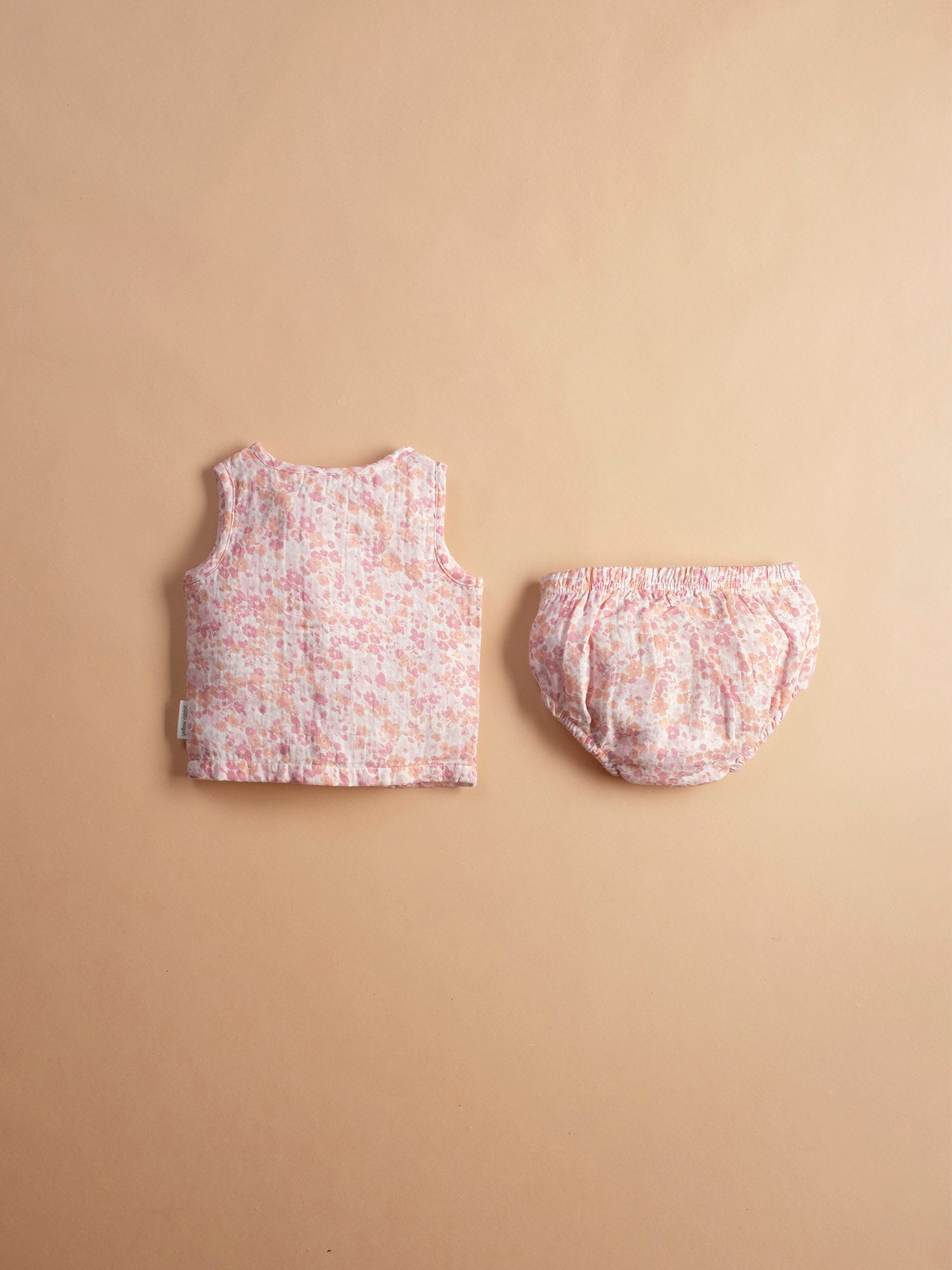 Soft muslin infant jhabla sei in cherry blossom print with matching bloomers-breathable and gentle for newborn skin.