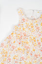 Golden Meadow Dress for girl's in soft yellow organic cotton, featuring a delicate floral print inn earthy tones, sleeveless and a breezy A-line silhouette.