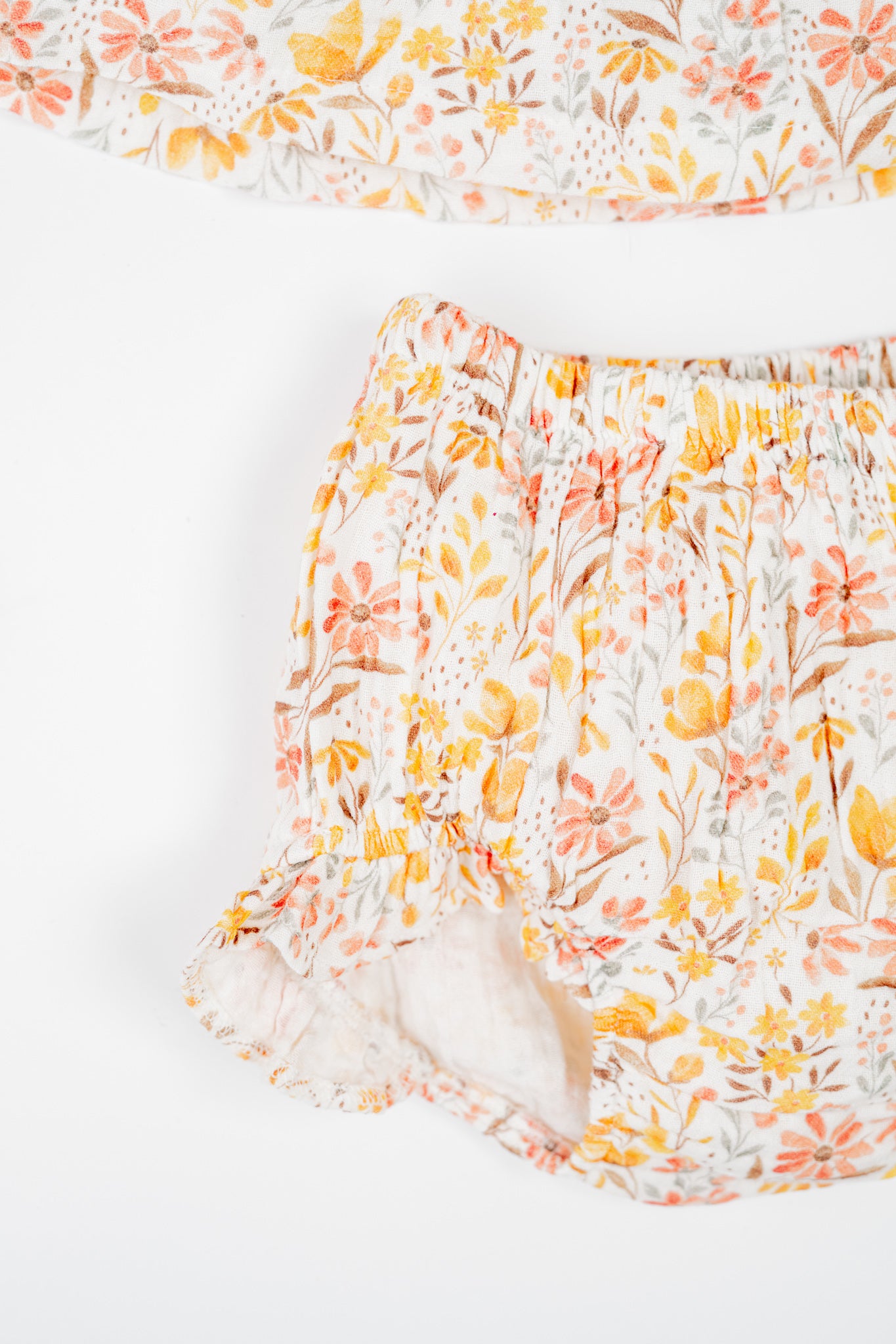 Baby girl's jhabla set with golden meadow floral print - sleevelss smocked top with ruffle straps and matching bloomers, made from soft, breathable, organic cotton.