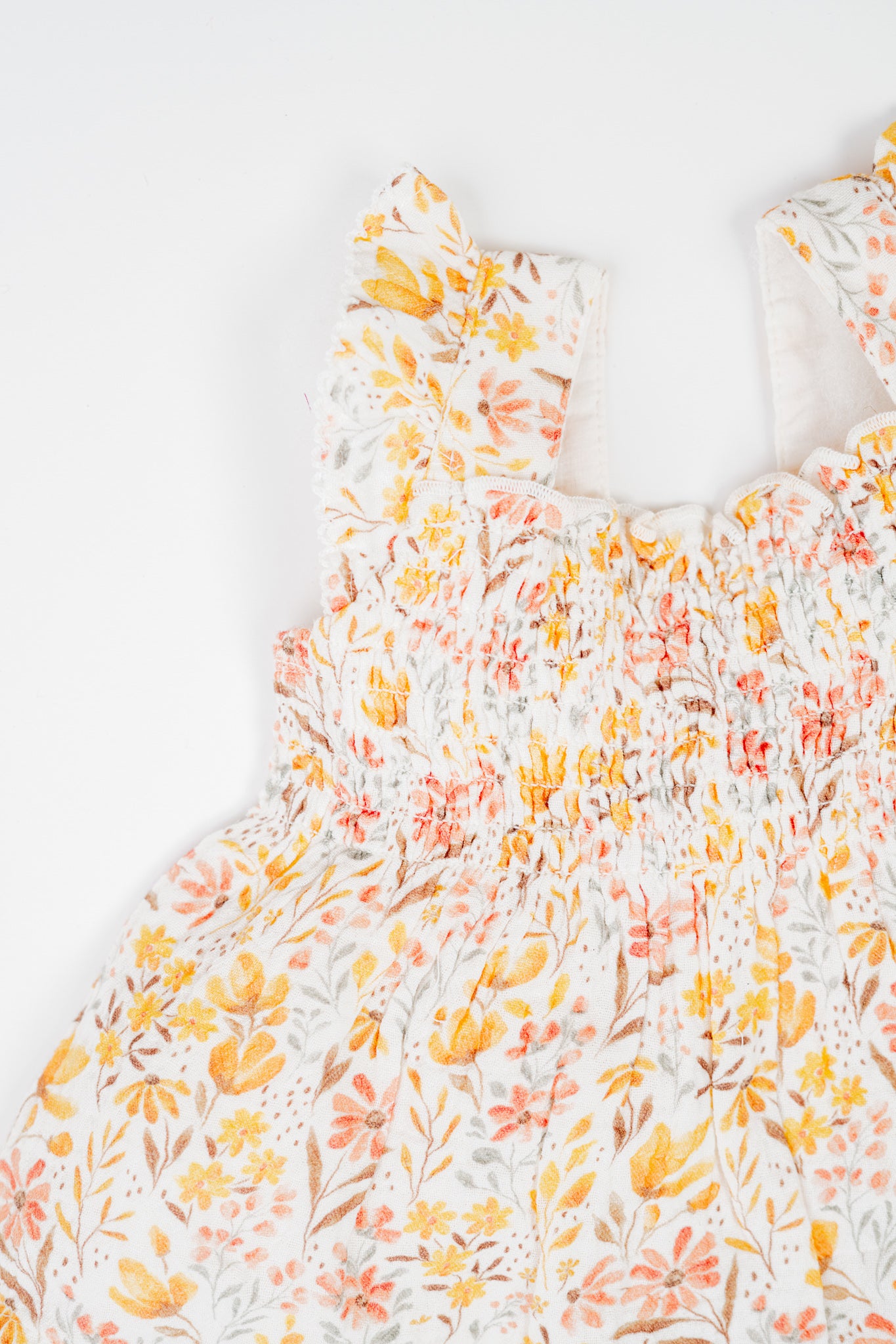 Baby girl's jhabla set with golden meadow floral print - sleevelss smocked top with ruffle straps and matching bloomers, made from soft, breathable, organic cotton.