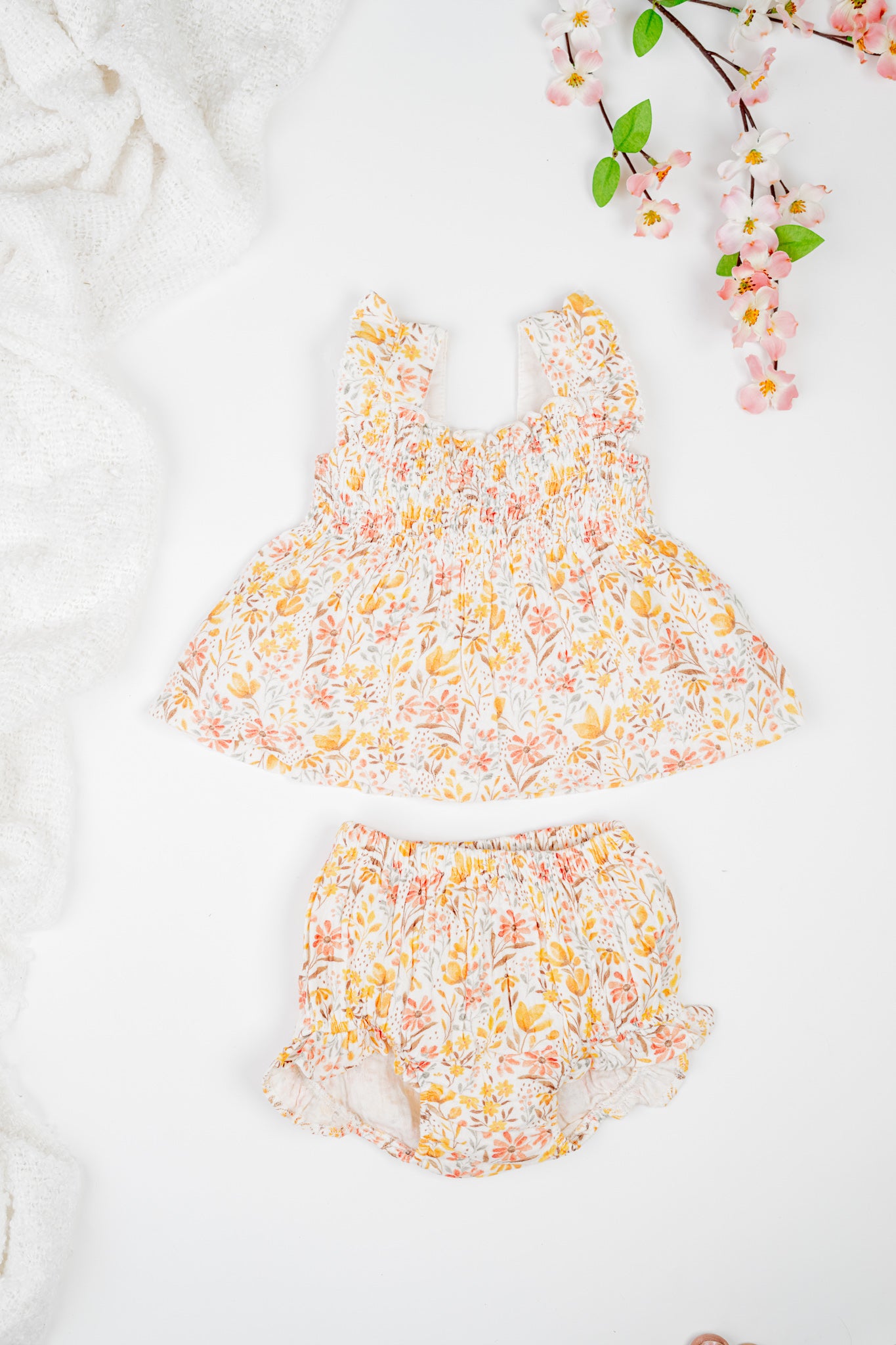 Floral baby girl's jhabla set with smocked top, sleeveless with ruffles and matching bloomers - soft cotton, and golden flowers print.