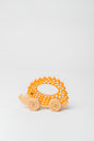 Cute wooden hedgehog toy with wheels, ideal for toddler play.