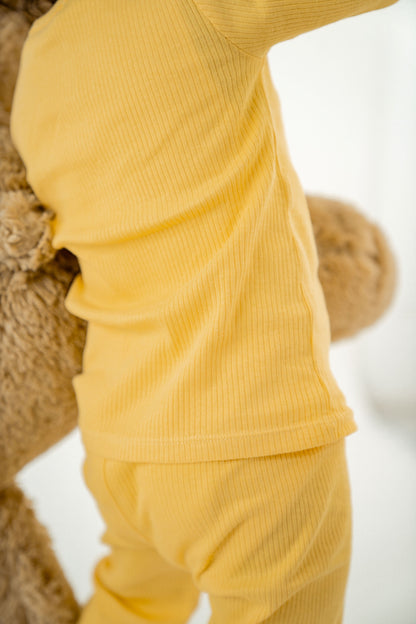Cozy up bedtime with Yellow Rabbit's organic knitted PJs for babies and toddlers.