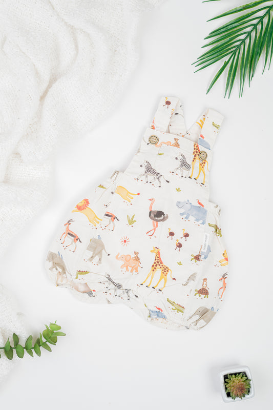 Kids' organic cotton overalls with water colour safari animal print, adjustable strap, and snap buttons for easy changes.