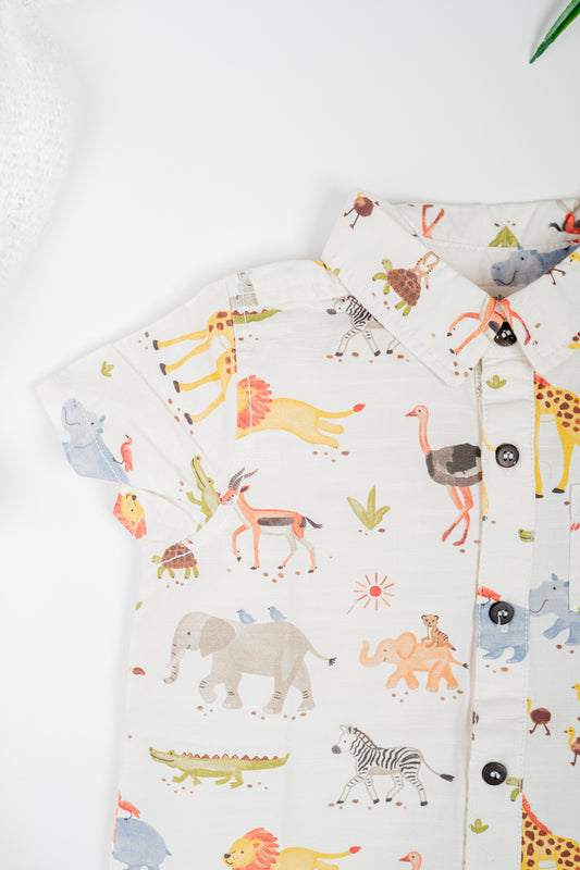 Kid's organic cotton shirt with all-over watercolor safari animal print, featuring short sleeves and a relaxed fit for everyday comfort.
