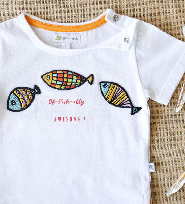 Organic cotton kids' T-shirt with colourful fish patches and Of-fish-ally Awesome! text-soft and playful summer wear for toddlers.