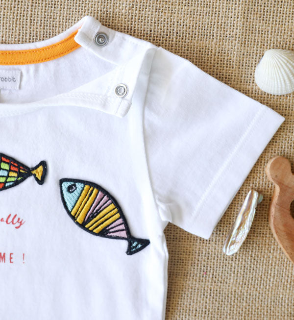 Organic cotton kids' T-shirt with colourful fish patches and Of-fish-ally Awesome! text-soft and playful summer wear for toddlers.