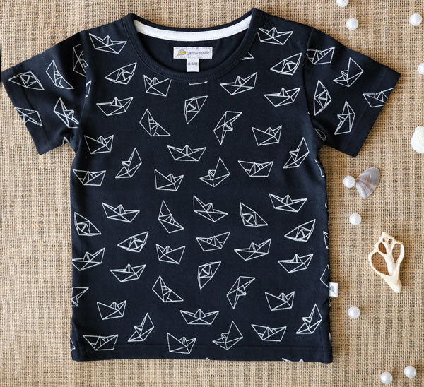 Navy blue organic cotton t-shirt with white paper boat print for kids.