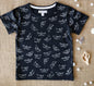 Navy blue organic cotton t-shirt with white paper boat print for kids.