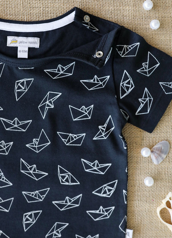 Navy blue organic cotton t-shirt with white paper boat print for kids.