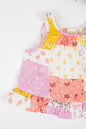 Infant organic cotton sleeveless jhabla set with colourful patchwork print in shades of pink, yellow and white, featuring floral and geometric patterns. Soft, breathable fabric designed for newborn comfort.