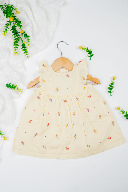 Infant girl's dress featuring a vibrant yellow hue with delicate tulip embroidery.