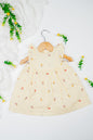 Infant girl's dress featuring a vibrant yellow hue with delicate tulip embroidery.