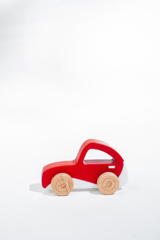 Sustainably made red wooden beetle toy with smooth wheels for pushing or pulling - toddler safe design.